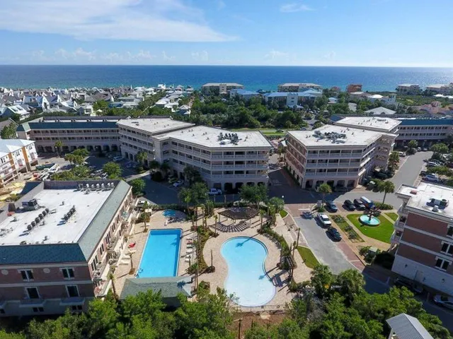 an aerial view of a house with a garden and mountain view