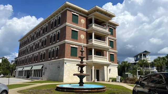 a front view of a building with a yard