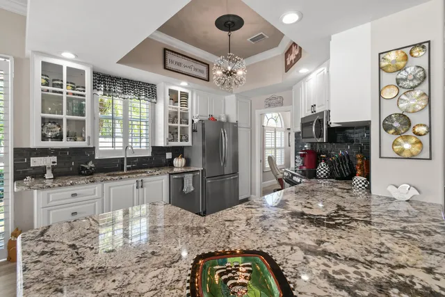 a bathroom with a granite countertop sink mirror vanity and toilet