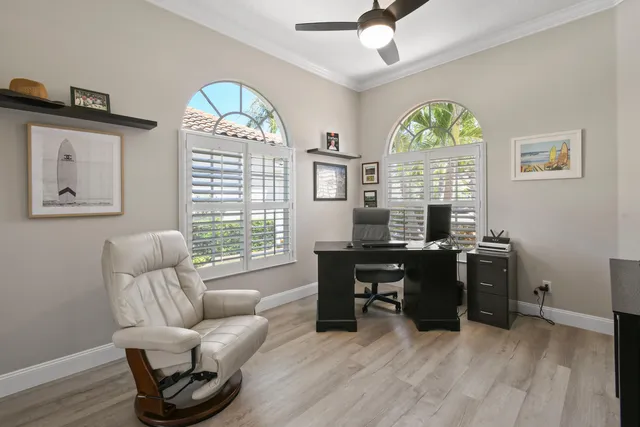 a bed sitting in a spacious bedroom next to a window
