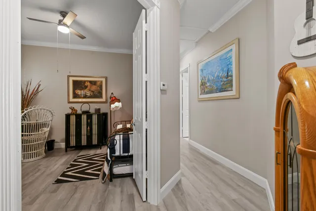 a view of a white house with a yard and potted plants