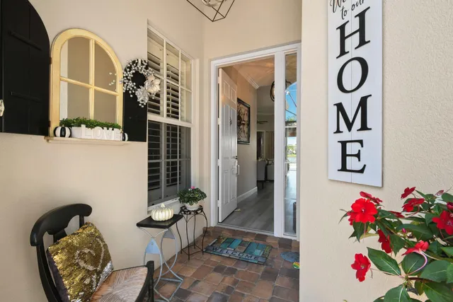 a living room with furniture kitchen view and a wooden floor