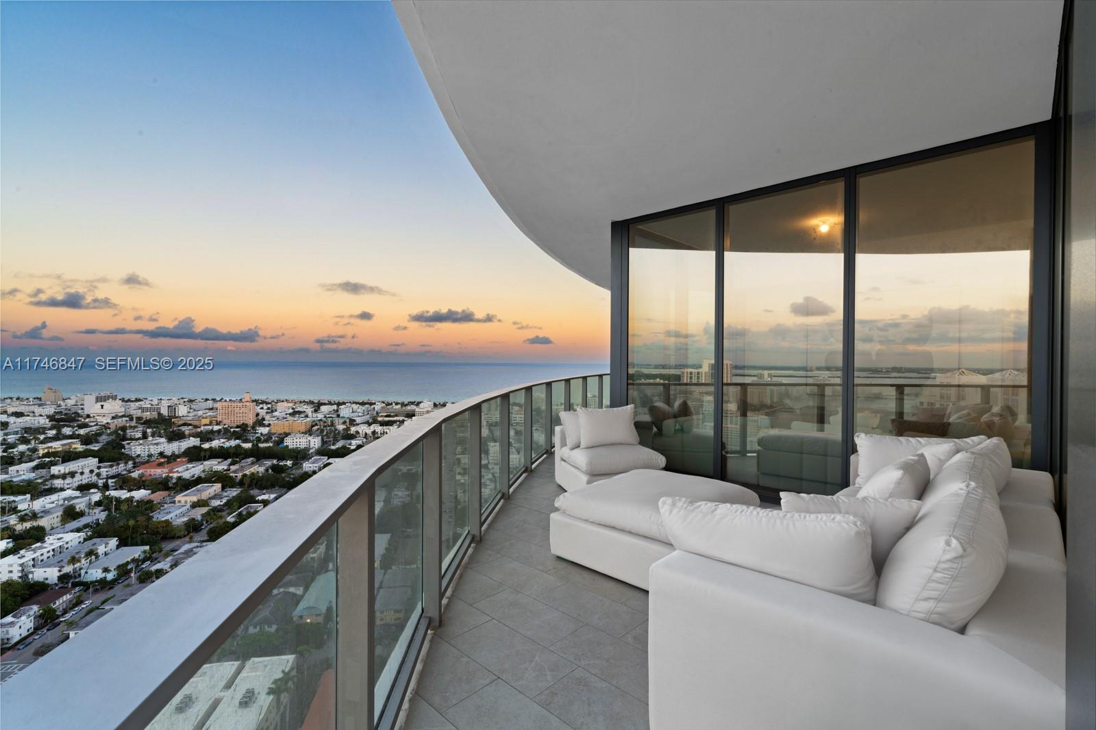 500 Alton Road, Unit 3303 Miami Beach, FL 33139 - Photo 1 of 1 a view of a balcony with couches and city view