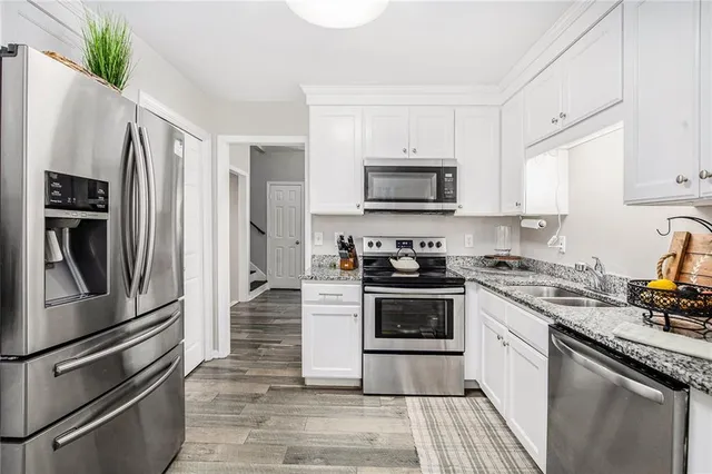a kitchen with a refrigerator stove and sink