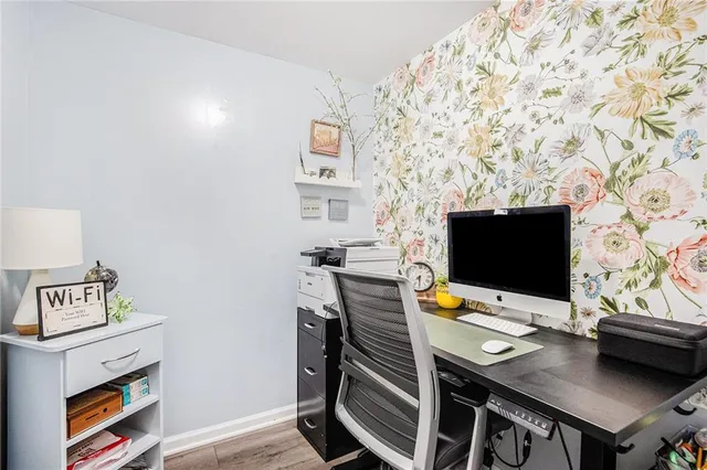 a view of a workspace with furniture and wooden floor