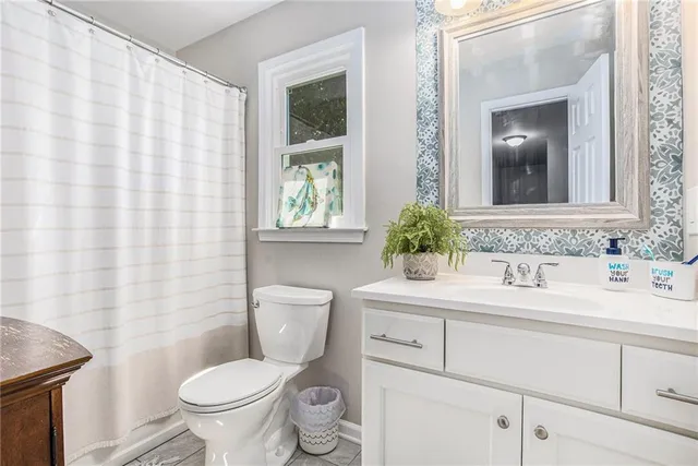 a bathroom with a sink toilet and mirror