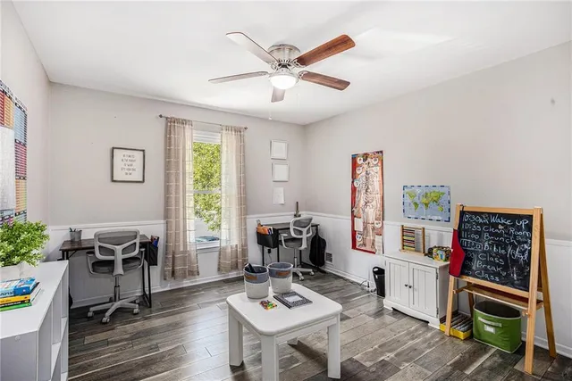 a view of a workspace with furniture and a window