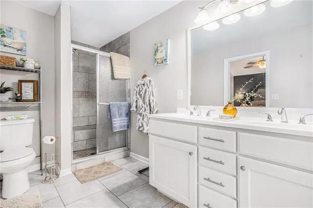 a spacious bathroom with a shower sink and mirror