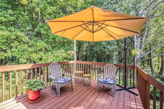 a view of a deck with furniture and wooden deck
