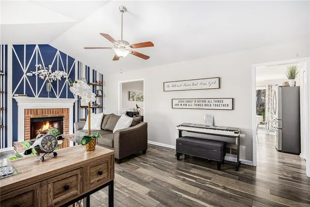 a living room with furniture a fireplace and a flat screen tv