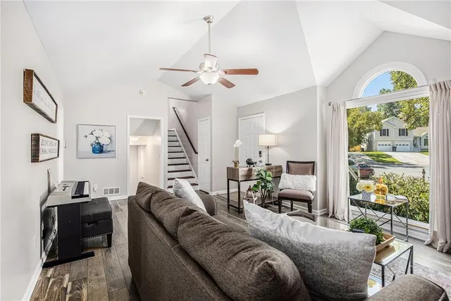 a living room with furniture a fireplace and a window