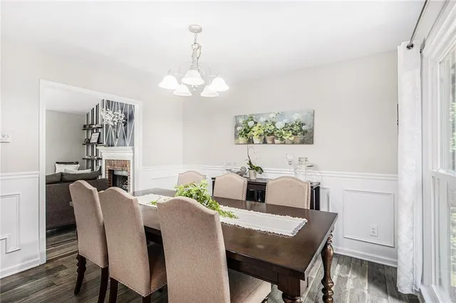 a view of a dining room with furniture a chandelier and wooden floor