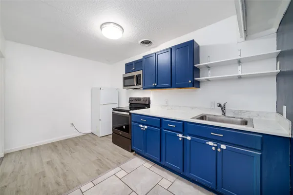 a kitchen with sink and cabinets