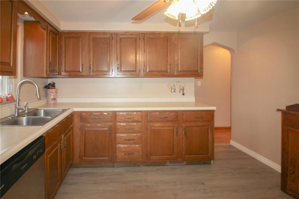 164 Gill Hall Road Clairton, PA 15025 - Photo 8 of 30 a kitchen with stainless steel appliances granite countertop a sink a stove and a wooden cabinets
