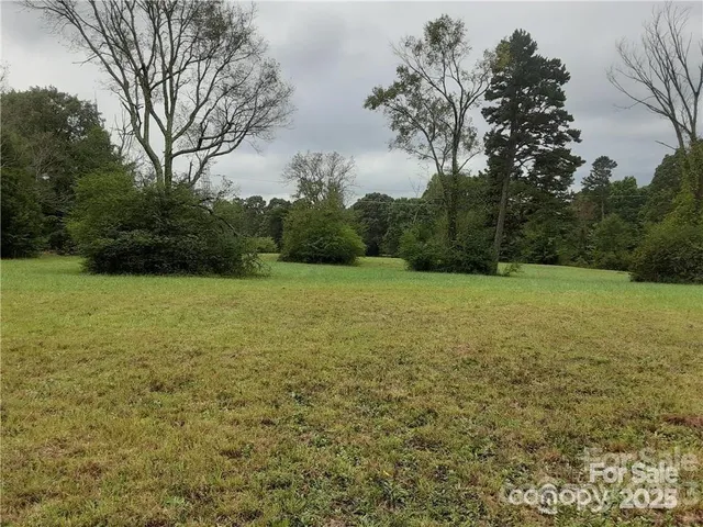 a view of a field with an trees