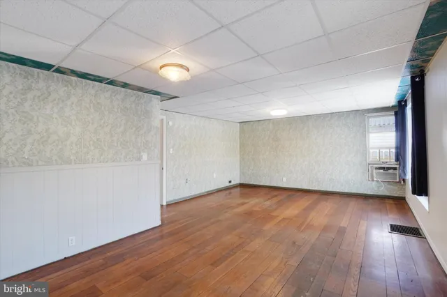 wooden floor in an empty room with a window