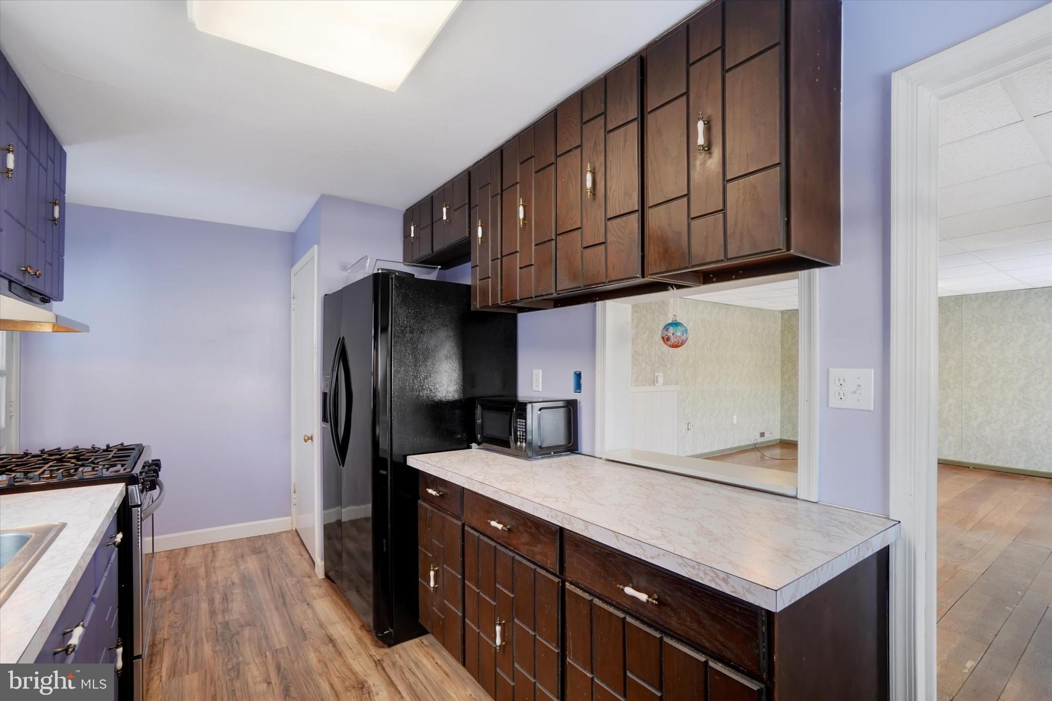 321 Frederick Court York, PA 17403 - Photo 7 of 24 a kitchen with stainless steel appliances granite countertop a refrigerator a sink dishwasher a stove and a microwave oven on the wooden floor