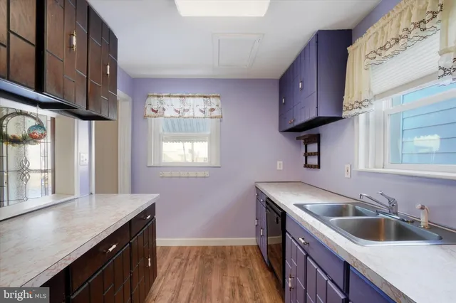 a kitchen with wooden cabinets a sink and a stove