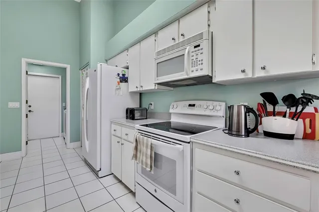 a kitchen with stainless steel appliances white cabinets and a window