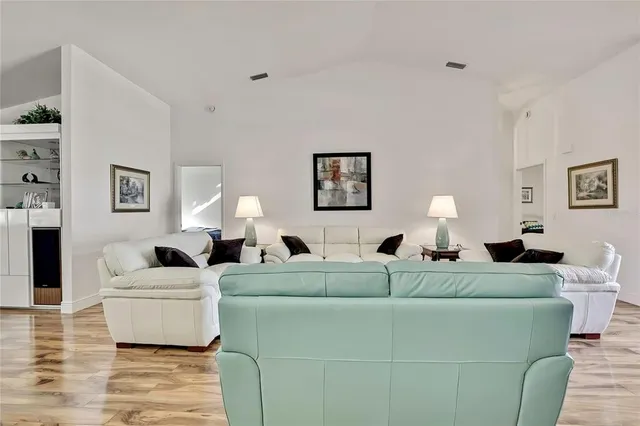 a living room with furniture and a lamp