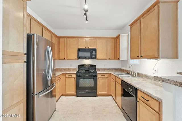 a kitchen with a sink stove and refrigerator