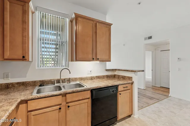 a kitchen with a sink cabinets and window