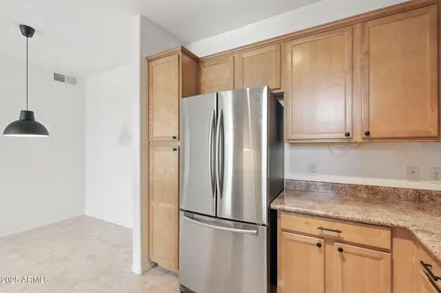 a kitchen with stainless steel appliances granite countertop a refrigerator and a sink