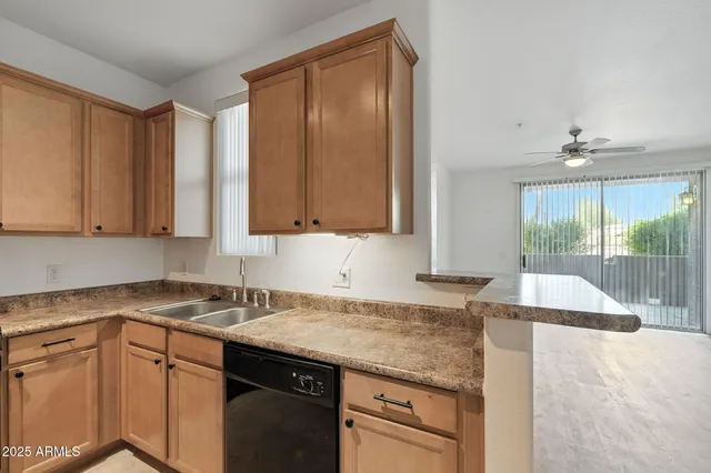 a kitchen with stainless steel appliances granite countertop a sink a stove cabinets and wooden floor