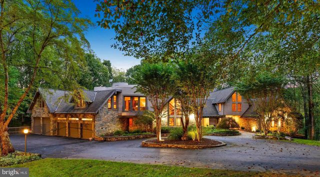 a view of a house with pool and chairs