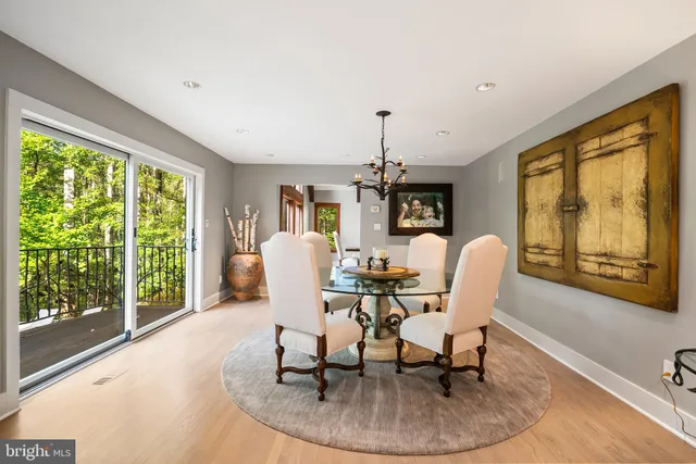 a living room with furniture a piano and a potted plant
