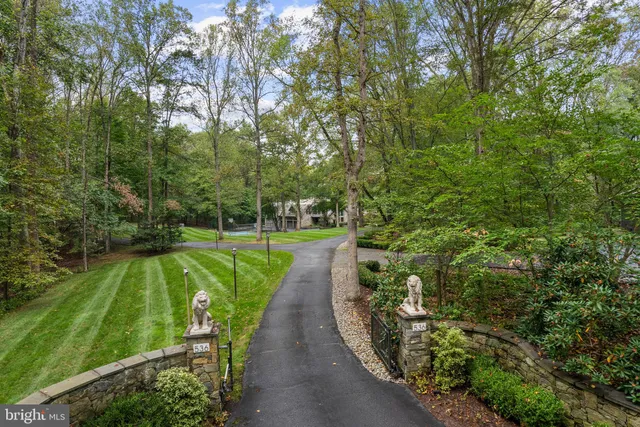 an aerial view of a house with garden space and street view