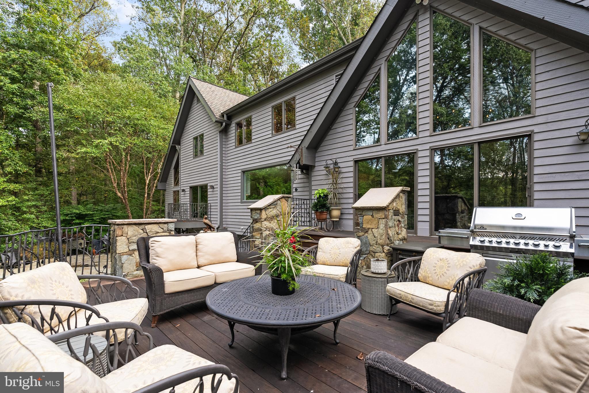 536 Springvale Road Great Falls, VA 22066 - Photo 22 of 139 a view of a patio with couches potted plants and a wooden bench
