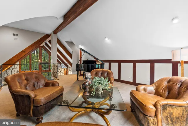 a dining room with furniture a large window and potted plants