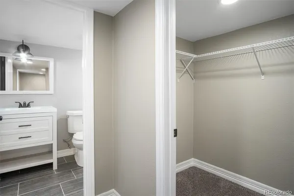 a bathroom with a sink vanity and a toilet