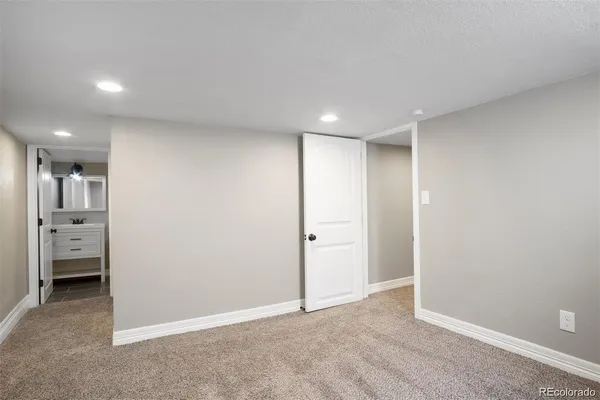 an empty room with a cabinet and a window