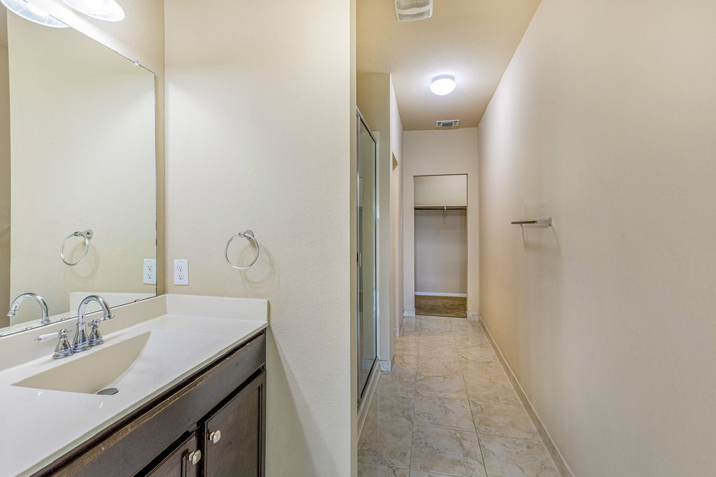 12105 Greywacke Drive Manor, TX 78653 - Photo 11 of 18 a bathroom with a sink and a mirror