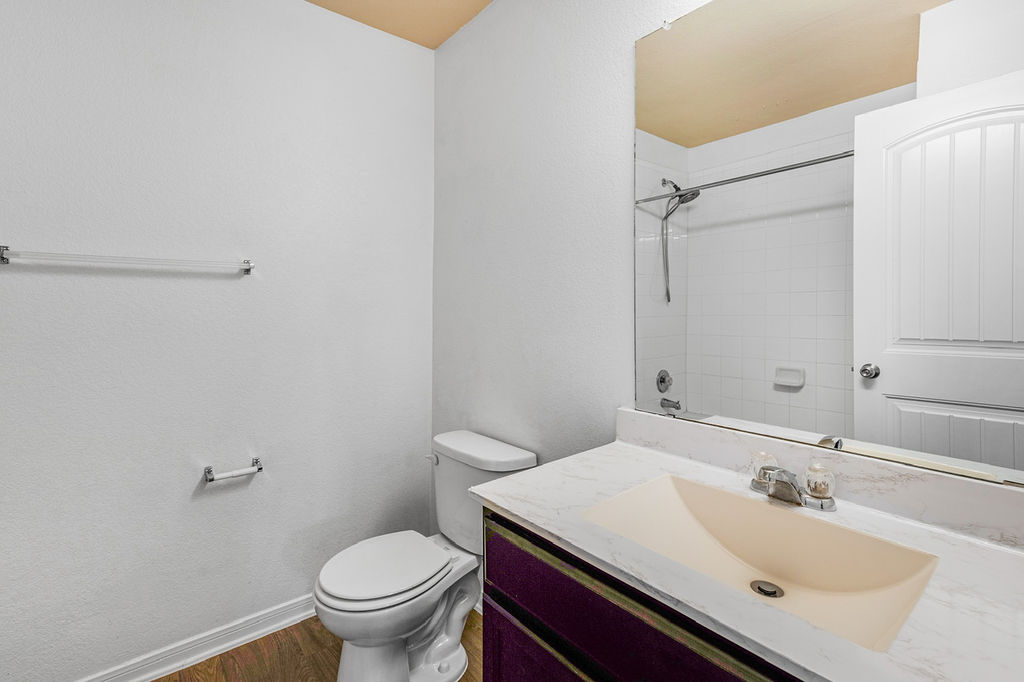 12105 Greywacke Drive Manor, TX 78653 - Photo 13 of 18 a bathroom with a sink toilet and a mirror