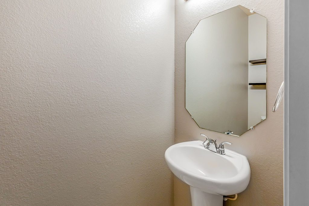 12105 Greywacke Drive Manor, TX 78653 - Photo 14 of 18 a bathroom with a sink and a mirror