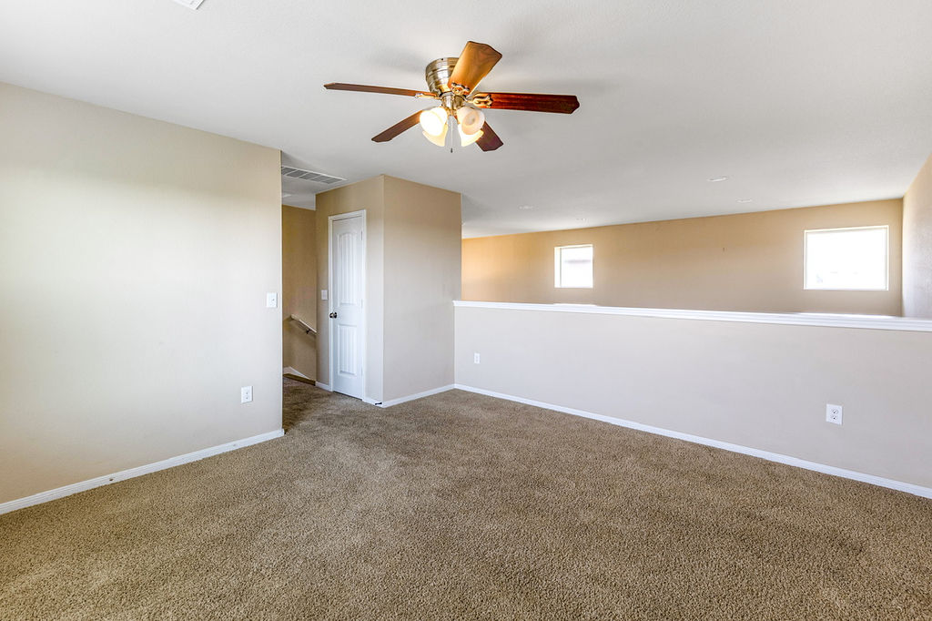 12105 Greywacke Drive Manor, TX 78653 - Photo 4 of 18 a view of a room with a ceiling fan and window