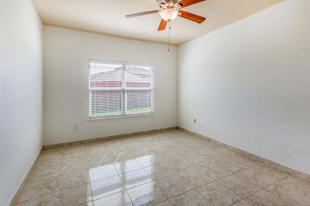 12105 Greywacke Drive Manor, TX 78653 - Photo 5 of 18 an empty room with windows and fan