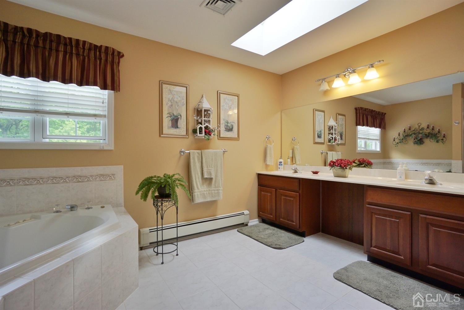 54 Stratton Road Old Bridge, NJ 07747 - Photo 12 of 23 a bathroom with a tub sink and mirror