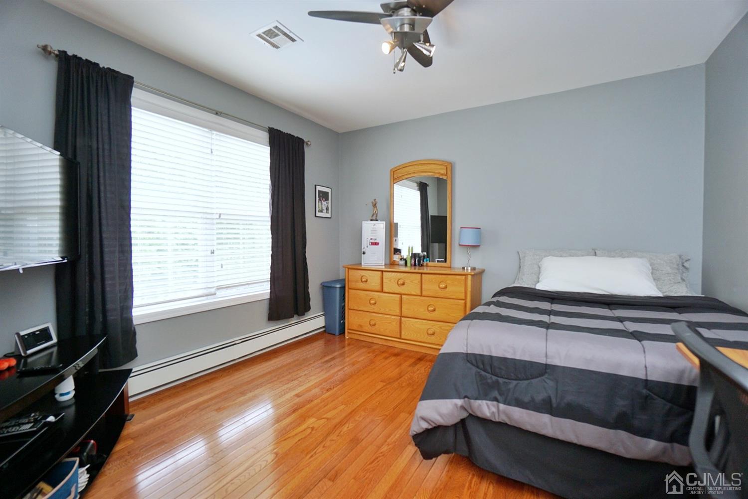 54 Stratton Road Old Bridge, NJ 07747 - Photo 16 of 23 a bedroom with a bed and wooden floor