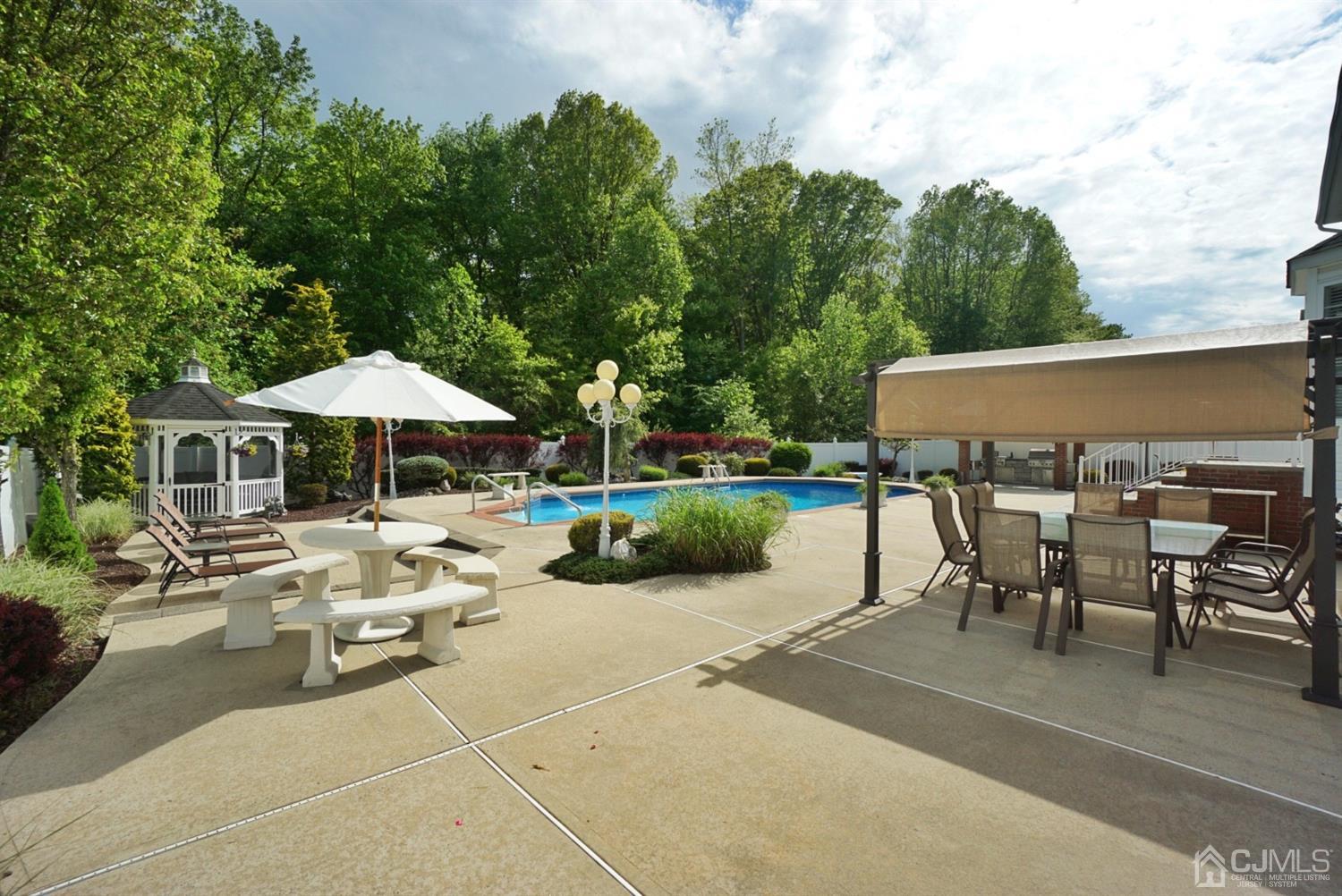 54 Stratton Road Old Bridge, NJ 07747 - Photo 21 of 23 a view of a patio with table and chairs under an umbrella