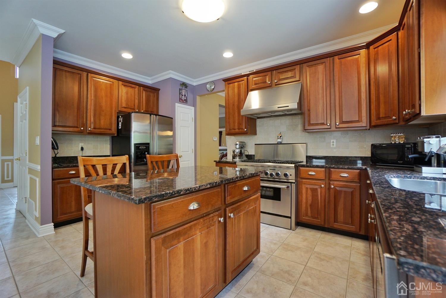 54 Stratton Road Old Bridge, NJ 07747 - Photo 5 of 23 a kitchen with stainless steel appliances granite countertop a stove top oven a sink dishwasher and a refrigerator