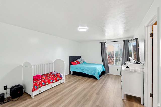 3689 Lasso Loop Circle Magna, UT 84044 - Photo 8 of 26 Primary Bedroom featuring wood-finish flooring and white walls