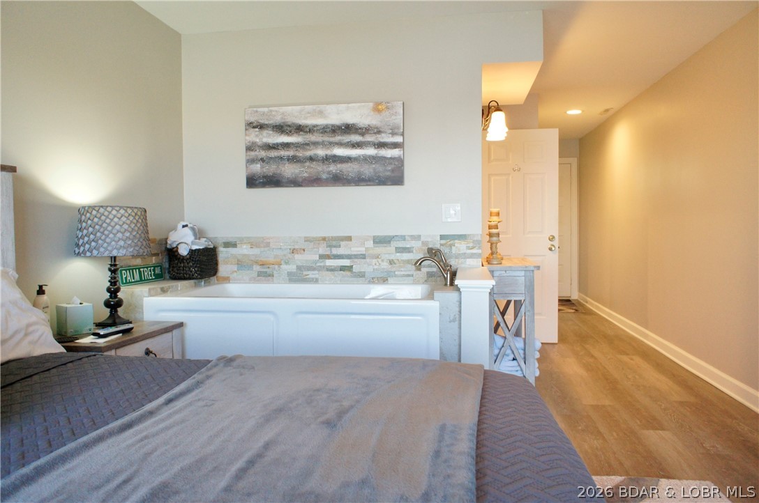 5940 Baydy Peak Road, Unit 112 Osage Beach, MO 65065 - Photo 24 of 51 Jetted Tub in Primary Bedroom