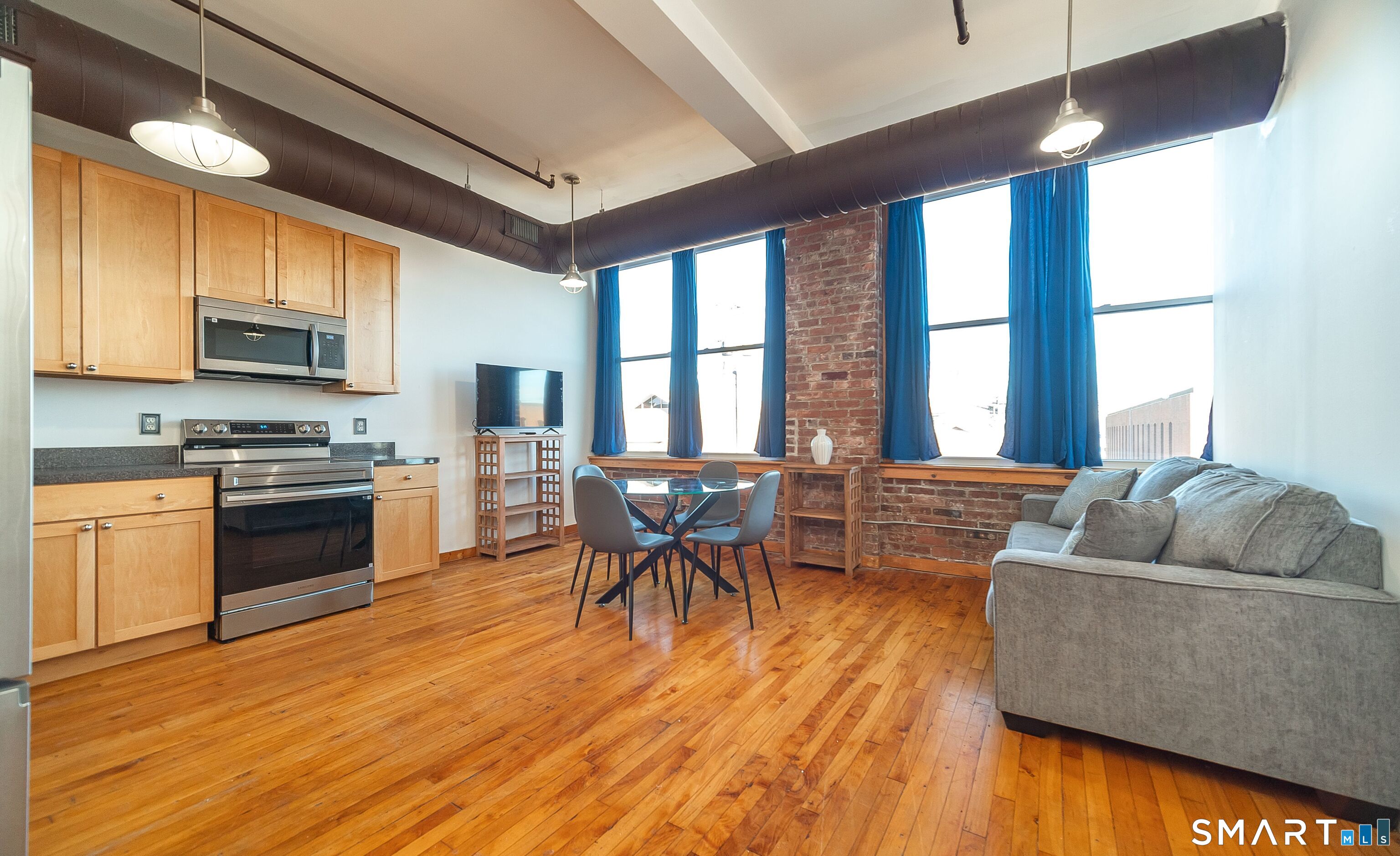 325 Lafayette Street, Unit 8205 Bridgeport, CT 06604 - Photo 1 of 23 a living room with furniture and a wooden floor