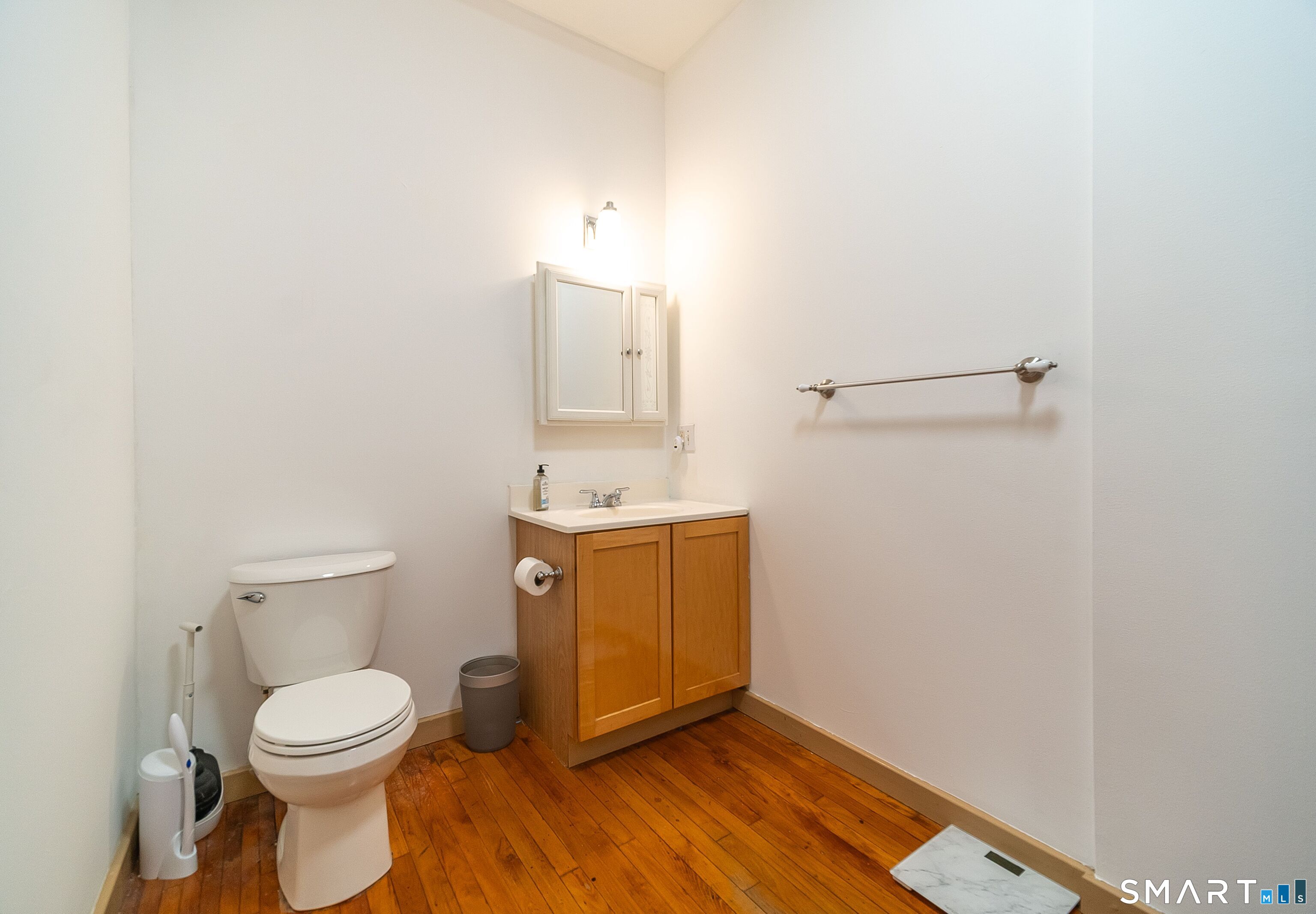 325 Lafayette Street, Unit 8205 Bridgeport, CT 06604 - Photo 14 of 23 a bathroom with a toilet a sink and mirror