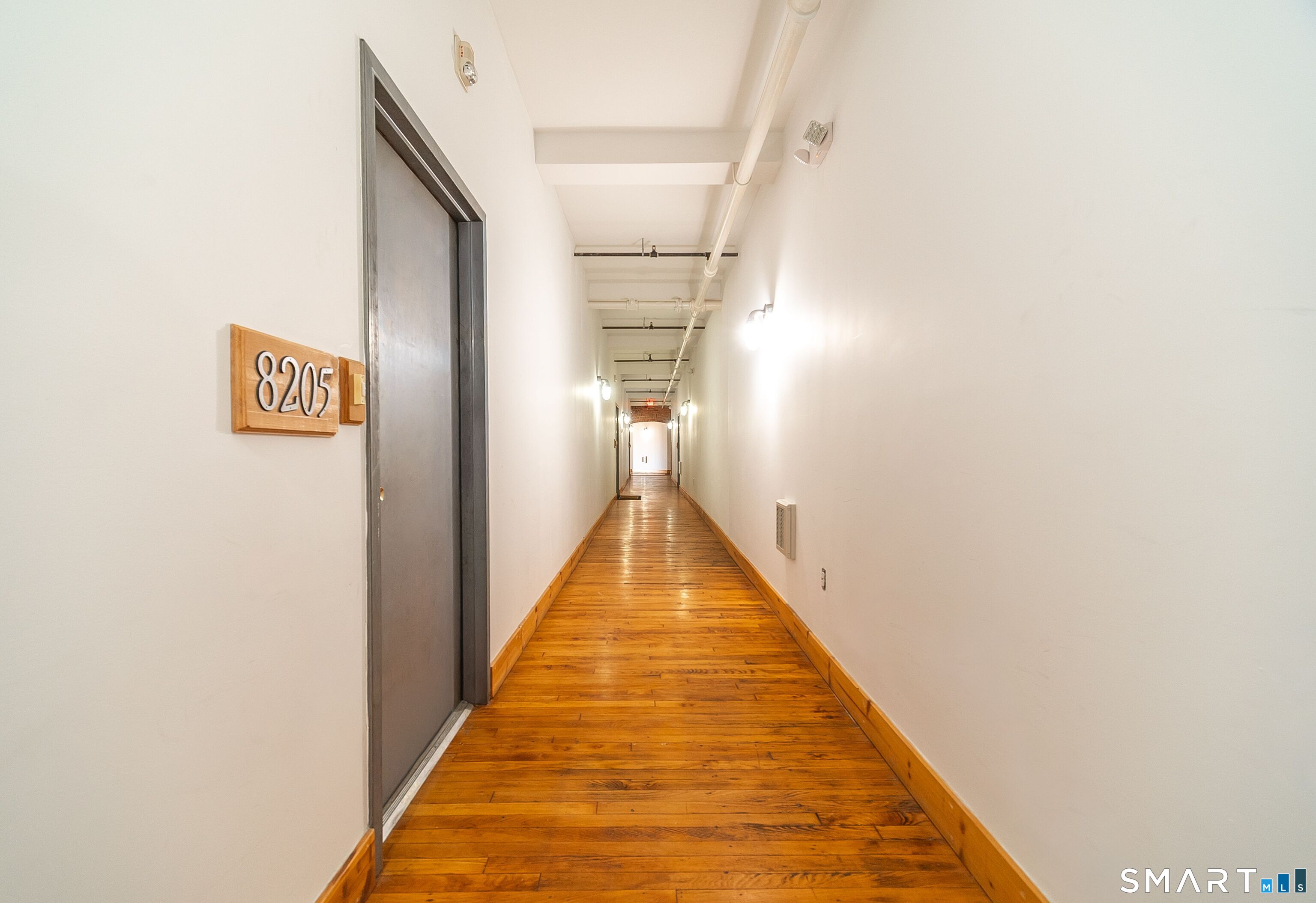 325 Lafayette Street, Unit 8205 Bridgeport, CT 06604 - Photo 16 of 23 a view of a hallway with wooden floor and a bathroom