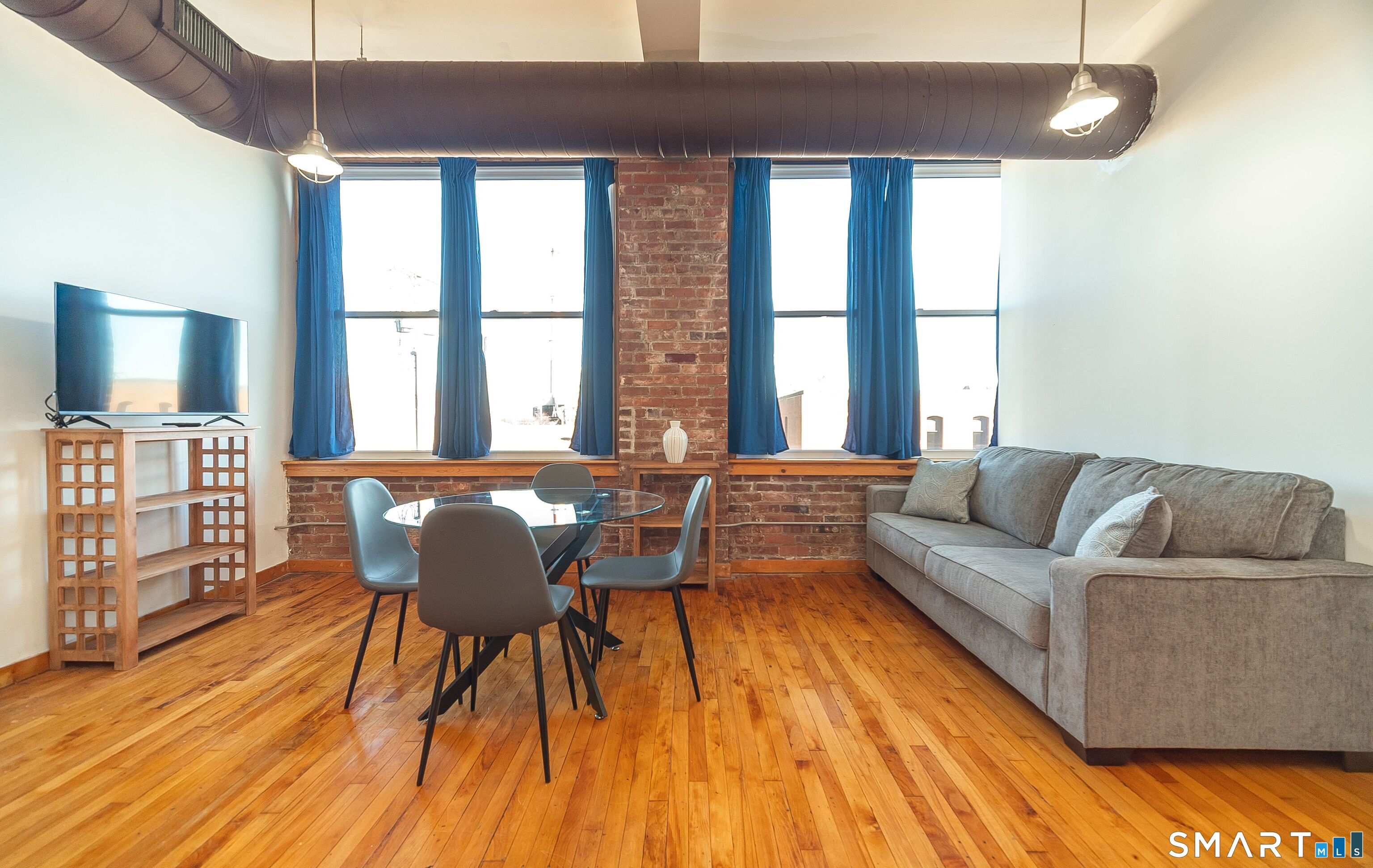 325 Lafayette Street, Unit 8205 Bridgeport, CT 06604 - Photo 2 of 23 a living room with furniture and wooden floor